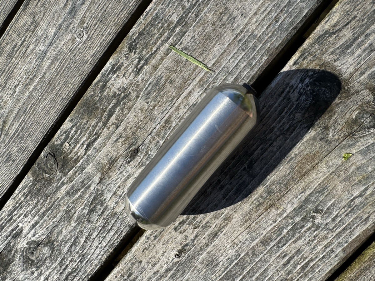An oblong stainless steel float with a threaded end fitting
